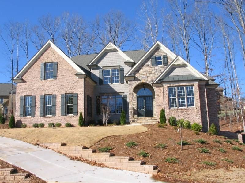 Custom home with arched stone entry